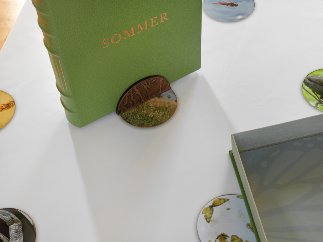 Sommer Clamshell Portfolio. Leather, pigmented ink fabric, book cloth. 9.5"w x 12"h x 2"d. 2015. Book stand. Copper, leather. 4"w x 2"h x 2.5"d. 2017. Sommer Tablecloth. Pigmented ink on satin. 44" x 84". 2017.