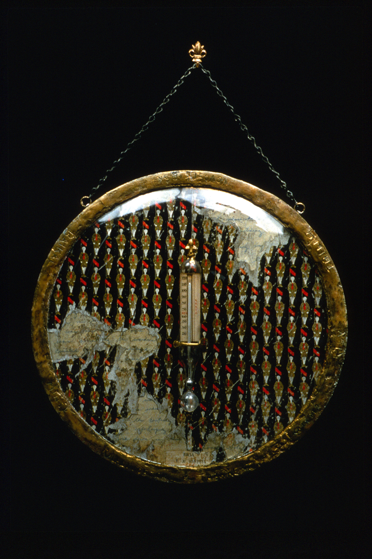 Minus 12. Glass, wood, thermometer, paint, wax, metal. (Prisoners were forced to work in the coldest places on Earth. Not allowed in the twelve main cities in Russia, referred to as Minus 12 program.) 14" round, with hanger L. 19", 1.5" d. 1999